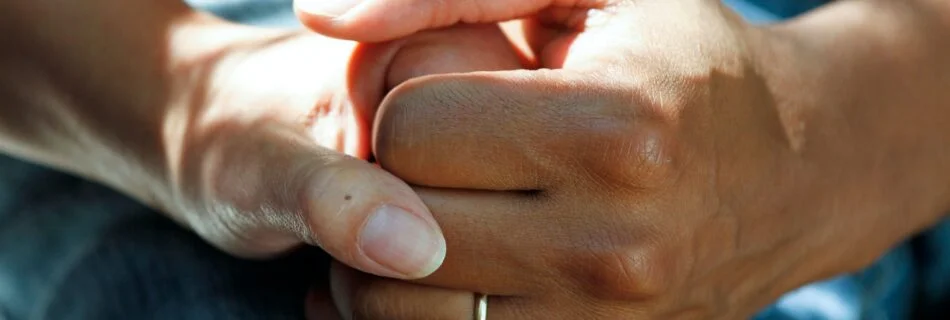 person wearing gold wedding band